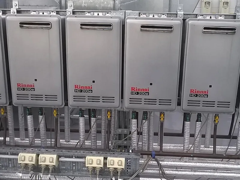 Four Rinnai HD200e heaters with electrical outlets and pipework below