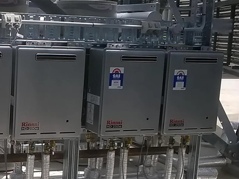 Three Rinnai commercial heaters with GAS approval labels on a steel frame